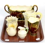 A Beleek foliate decorated jug, cream jug, milk jug and a small planter together with a Carlton ware