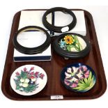 Three Moorcroft Pottery coasters, Plume by Emma Bossons, Snowberry by Nicola Slaney and Porporo by