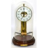 An electric mantel timepiece beneath glass dome, base with plaque inscribed Nov 4th 1922