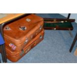 Two leather suitcases, gun case, two riding crops, Ghana tribal artifacts etc