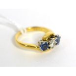 An 18ct gold diamond and sapphire three stone ring, 0.25ct approximately