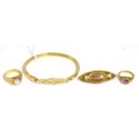 A 9ct gold Celtic motif bangle, a 9ct gold amethyst ring, a 9ct gold cubic zirconia ring, a 9ct go