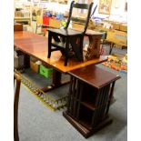 A revolving bookcase; brass fender; metamorphic library chair and a nest of three Ercol style tables