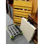 A folding three tier bookcase, trestle table and a folding sack barrow