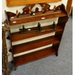 A group of assorted furniture including an open bookcase, luggage stand, folding cake stand and coat