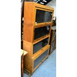 An oak sectional bookcase stamped 'Kidos' office furniture