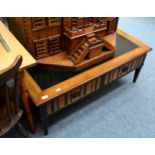 A modern part ebonised coffee table fitted with four drawers and two slides