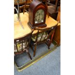 A German mantle clock in arched case; together with a pierced brass fire kerb