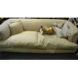 A cream Chesterfield style sofa