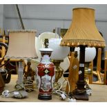 A group of seven lamps including two brass oil lamps, together with various silk shades
