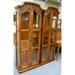 A pair of American glazed display cabinets by Drexl Herritage Furnishings