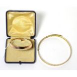 A 9 carat rose gold hinge opening bangle and a Greek key design arm bangle, stamped '9CT' (2)30.8g