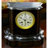 An ebonised and brass striking mantel clock