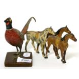 A cold painted bronze model of a pheasant and a painted metal model of three horses