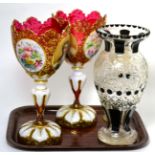 A pair of Bohemian white overlay glass vases (one a.f.); another engraved glass vase; and a gilt