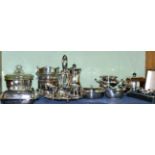 A silver three piece cruet set in a fitted case; an electroplated egg cruet complete with spoons;