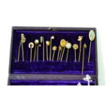 Seventeen various gold and other stick pins, including a diamond set example and a seed pearl oak