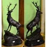 A pair of reproduction bronzed figures of stags