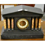 A Victorian black slate striking mantel clock