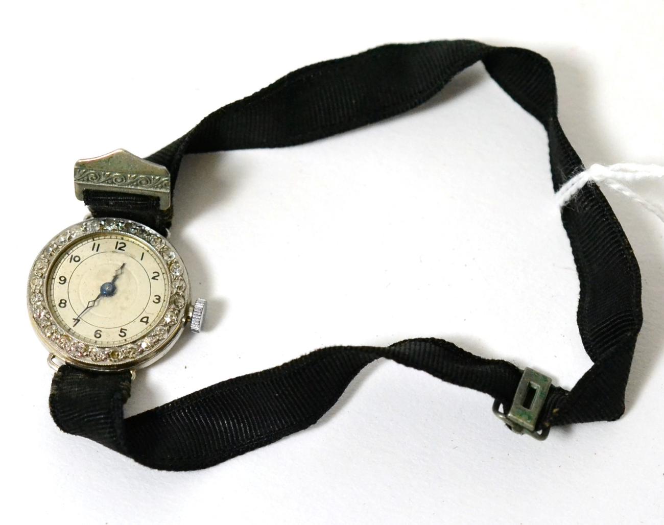 A lady's diamond set cocktail watch, on a black fabric strap, case stamped 'platine'