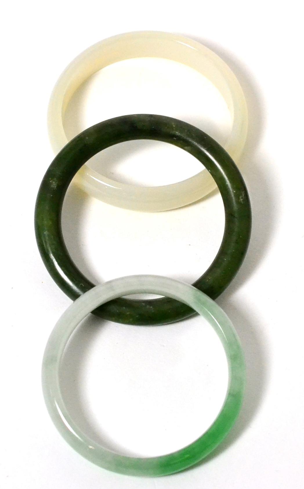 A jade bangle, a nephrite bangle and another bangle (3) 124.91g gross