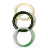 A jade bangle, a nephrite bangle and another bangle (3) 124.91g gross