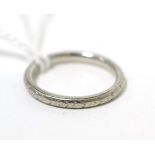 A floral engraved band ring, finger size K, stamped 'PLATINUM'3.8g gross