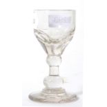 An early 19th century glass with a double knop stem