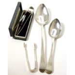 Two Georgian silver spoons, two sugar tongs and 'sterling' cocktail stirrer