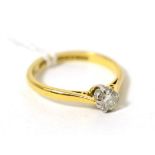 An 18 carat gold solitaire diamond ring, estimated diamond weight 0.35 carat approximately Finger