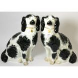 A pair of large 19th century Staffordshire black and white spaniels Hairline crack to the base of