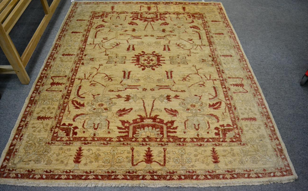 A Chobi rug, Afghan/Pakistan, the cream field of angular vines enclosed by floral borders, 199cm