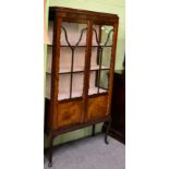 An early 20th century mahogany display cabinet, astragal glazed doors and sides, cabriole legs