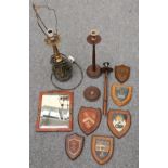 A pair of turned candlesticks, a lacquered framed mirror, six painted armorial shields and a gold