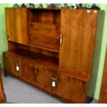 A 1960's Danish rosewood veneered wall unit, the upper section with open central compartment,