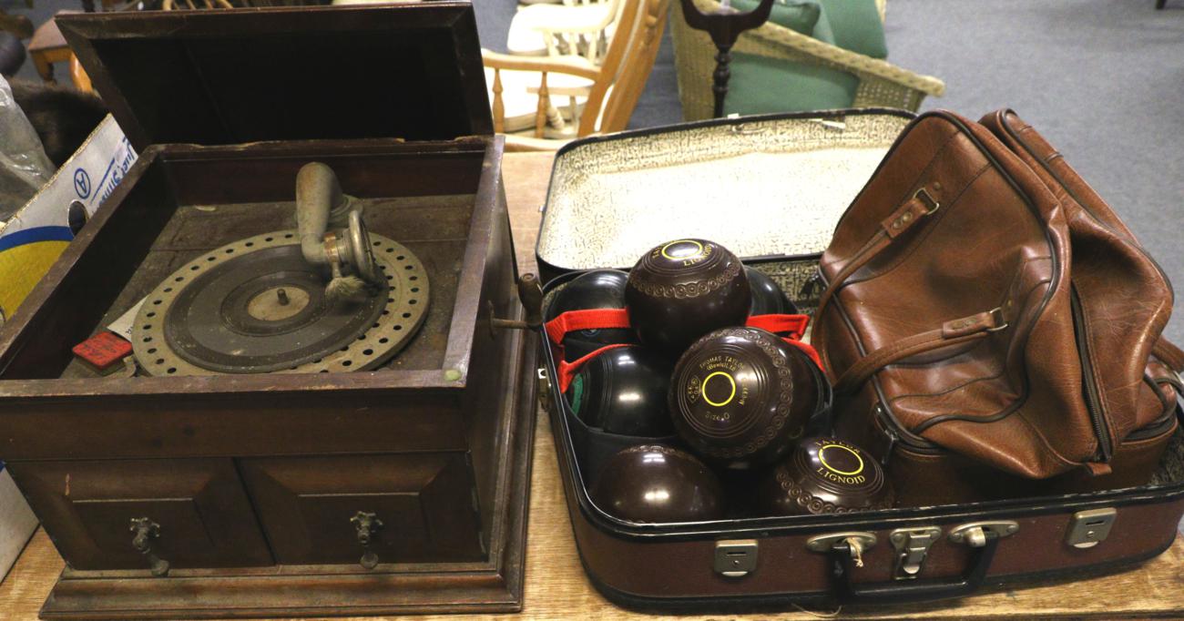 A mahogany cased gramophone and bowling balls