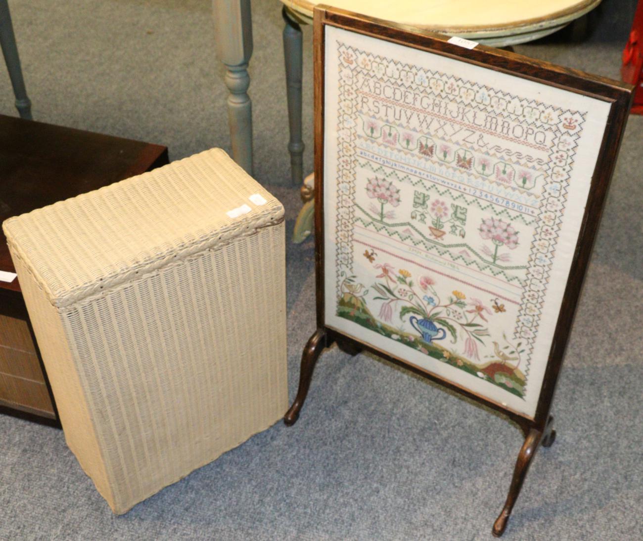 A fire screen with an inset sampler to one side and silk embroidery to the other, and a Lloyd loom