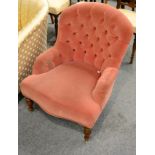 A pink button back nursing chair