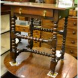 An oak side table with bobbin turned legs