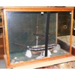 A Victorian maple framed display case enclosing a scratch built galleon