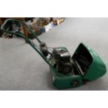 Cylinder petrol lawn mower with scarifier attachment