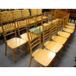 A set of twelve faux bamboo dining chairs, with turned spindle back support, 41cm wide