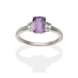 An 18 Carat White Gold Purple Sapphire and Diamond Ring, an oval cut purple sapphire in a claw
