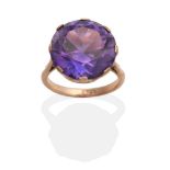 An Amethyst Ring, a round cut amethyst in a claw setting, to knife edge shoulders, finger size M see