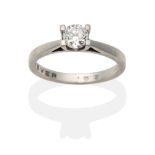 A Platinum Diamond Solitaire Ring, a round brilliant cut diamond in a claw setting, to knife edge