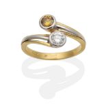 An 18 Carat Gold Diamond Two Stone Cross-Over Ring, a round brilliant cut white diamond and a