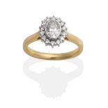 An 18 Carat Gold Oval Diamond Cluster Ring, an oval brilliant cut diamond in a rubbed over setting