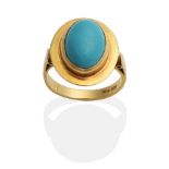 A Turquoise Ring, an oval turquoise in a rubbed over setting within an oval frame, to tapering