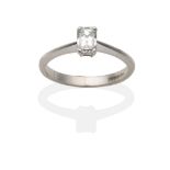An 18 Carat White Gold Millennium Cut Diamond Solitaire Ring, in a claw setting, to knife edge