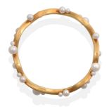 An 18 Carat Gold Cultured Pearl Bangle, an undulating bangle set throughout with vari-sized cultured